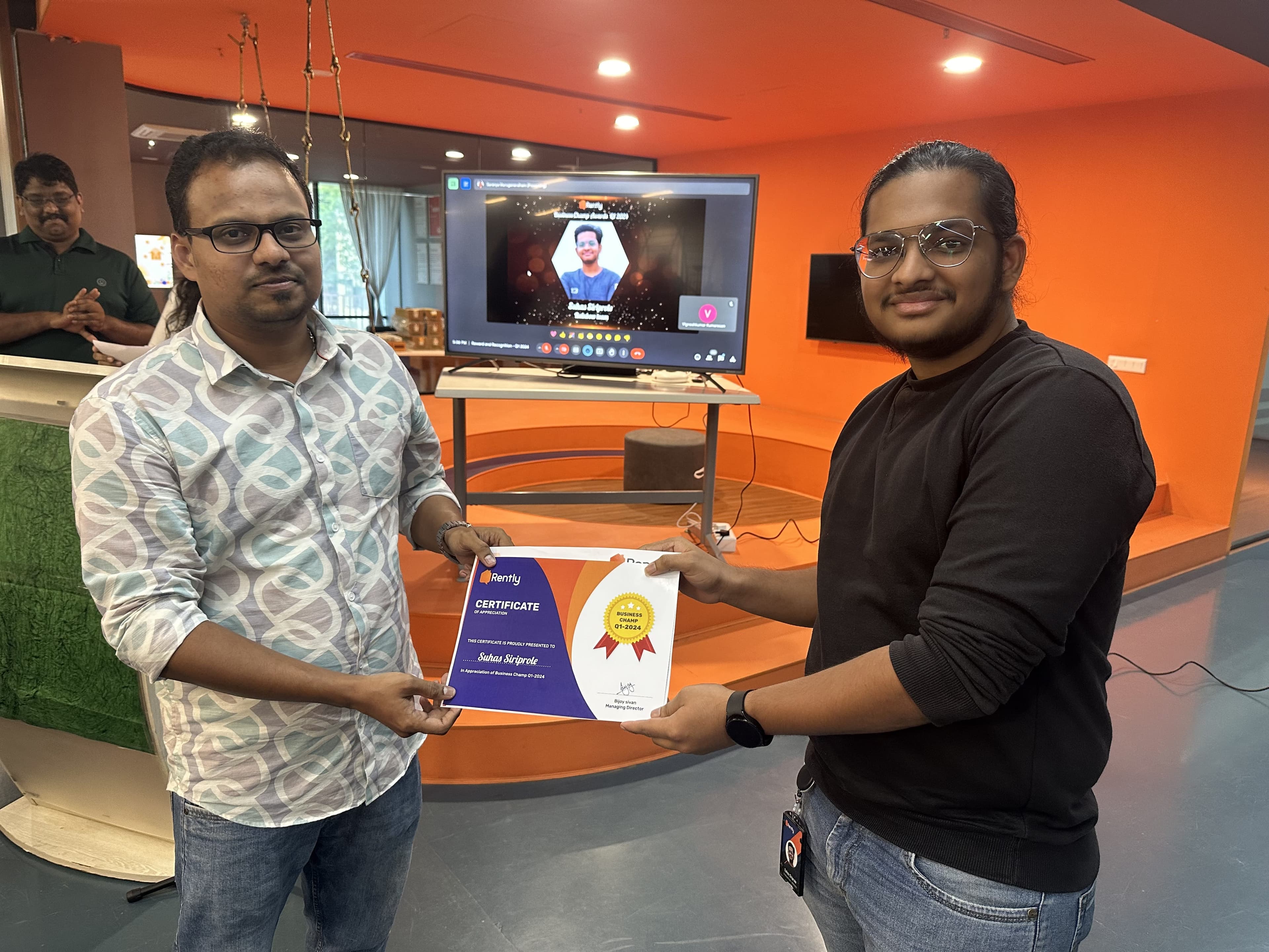 Suhas holding the Rently Business Champ award, Q1 2024
